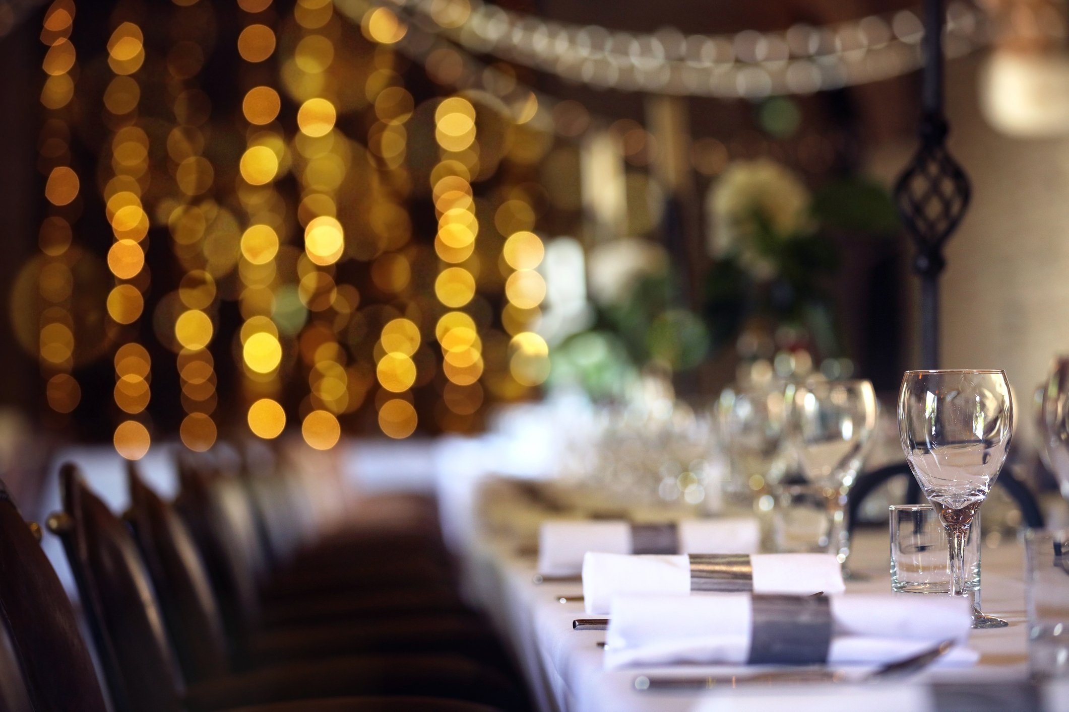 Formal wedding place setting on long table background